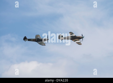 Supermarine Spitfire Mk XVI and Hawker Hurricane IIc in formation at the Flying Legends Airshow, Imperial War Museum Duxford Stock Photo