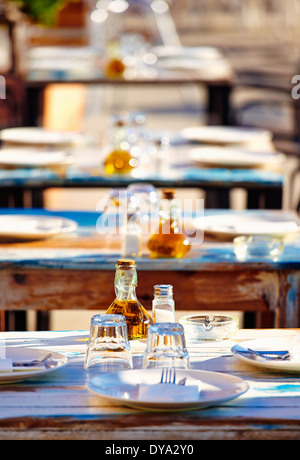 Outdoor restaurant tables ready for lunch. Denia. Alicante. Spain Stock Photo
