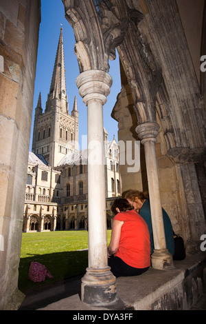 UK, England, Norfolk, Norwich, couple admiring Cathedral from cloisters Stock Photo