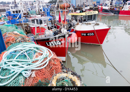 UK, England, Whitstable. Fishing nets and trawlers moored in the harbour Stock Photo