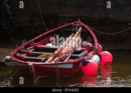 Small wooden sailing and rowing boat moored in the harbour at Ness on the Isle of Lewis Stock Photo