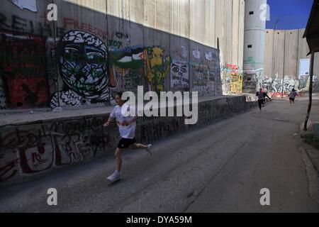 Bethlehem, West Bank, Palestine. 11th Apr, 2014. Participants run during the 2nd Palestine International Marathon in the West Bank city of Bethlehem on April 11, 2014. About 3,000 runners participated in the marathon this year, Palestinian officials said. Credit:  Luay Sababa/NurPhoto/ZUMAPRESS.com/Alamy Live News Stock Photo