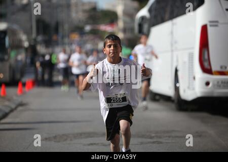 Bethlehem, West Bank, Palestine. 11th Apr, 2014. Participants run during the 2nd Palestine International Marathon in the West Bank city of Bethlehem on April 11, 2014. About 3,000 runners participated in the marathon this year, Palestinian officials said. Credit:  Luay Sababa/NurPhoto/ZUMAPRESS.com/Alamy Live News Stock Photo