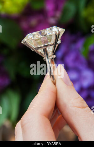 London, April 11th 2014. A woman at Sotheby's in London admires a round brilliant cut diamond, which at 103.46 carats is one of the largest of its type. It is expected to fetch between $3.5-5 million at auction in Geneva in May. Credit:  Paul Davey/Alamy Live News Stock Photo