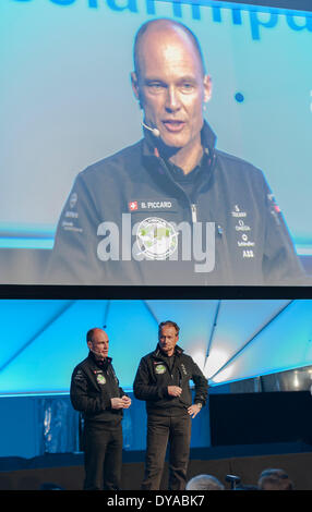 Payerne, Switzerland. 09th Apr, 2014. Bertrand Piccard (left) and Andre Borschberg on stage at the unveiling of 'Solar Impulse 2', a spectacular solar powered aircraft made to fly around the world without any fuel. Credit:  Erik Tham/Alamy Live News Stock Photo