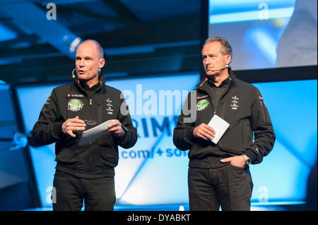 Payerne, Switzerland. 09th Apr, 2014. Bertrand Piccard (left) and Andre Borschberg on stage at the unveiling of 'Solar Impulse 2', a spectacular solar powered aircraft made to fly around the world without any fuel. Credit:  Erik Tham/Alamy Live News Stock Photo