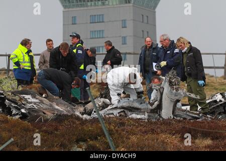 Schierke, Germany. 11th Apr, 2014. Police officers and officials of the German federal Bureau of Aircraft Accidents Investigation examine the accident scene after the air crash of a small aircraft on the mountain Brocken in Schierke, Germany, 11 April 2014. Two occupants died. Photo: Matthias Bein/dpa/Alamy Live News Stock Photo