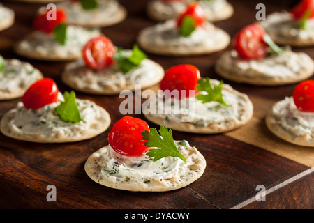 Cracker and Cheese Hors D'oeuvres with Tomato and Parsley Stock Photo