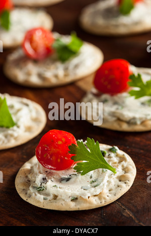 Cracker and Cheese Hors D'oeuvres with Tomato and Parsley Stock Photo