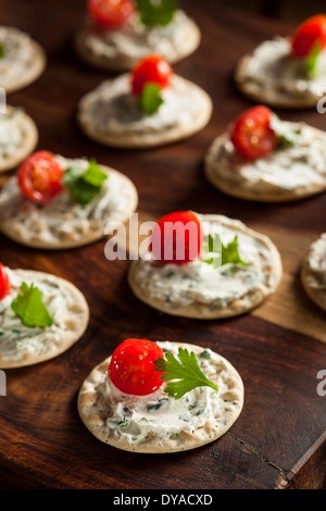 Cracker and Cheese Hors D'oeuvres with Tomato and Parsley Stock Photo