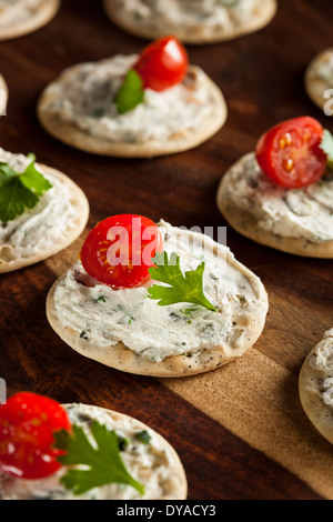 Cracker and Cheese Hors D'oeuvres with Tomato and Parsley Stock Photo