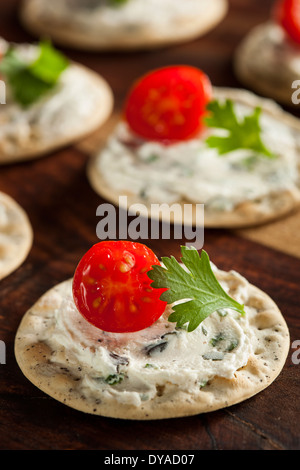 Cracker and Cheese Hors D'oeuvres with Tomato and Parsley Stock Photo