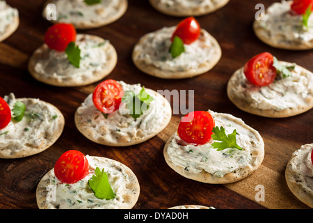 Cracker and Cheese Hors D'oeuvres with Tomato and Parsley Stock Photo