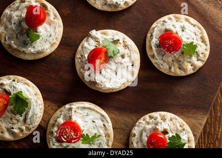 Cracker and Cheese Hors D'oeuvres with Tomato and Parsley Stock Photo