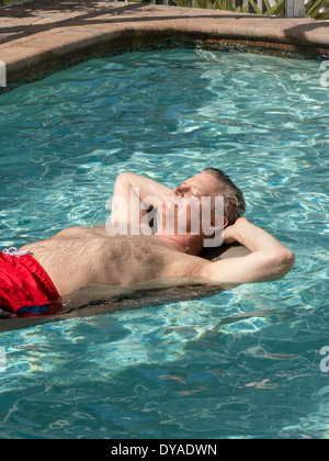 Mature Man Lounging in Pool, Punta Gorda, FL Stock Photo