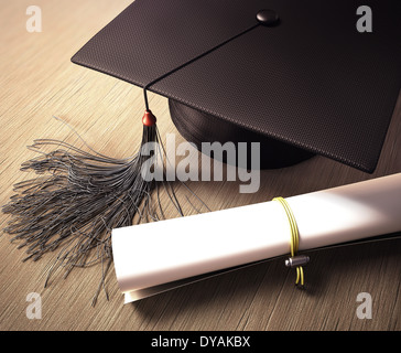 Graduation cap with diploma over the table. Clipping path included. Stock Photo