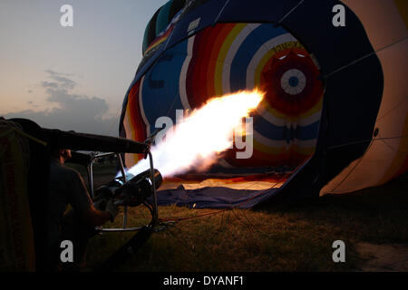 Lubao, Pampanga, Philippines. 11th Apr, 2014. A pilot prepares inflates his balloon with hot air at the Philippine International Hot Air Balloon Festival on April 11, 2014. The Philippine International Hot Air Ballon Festival featured 21 countries and over 30 balloons. Credit:  Mark Cristino/NurPhoto/ZUMAPRESS.com/Alamy Live News Stock Photo