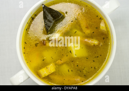 Soup with bacon, peas and vegetables and bay leaf Stock Photo