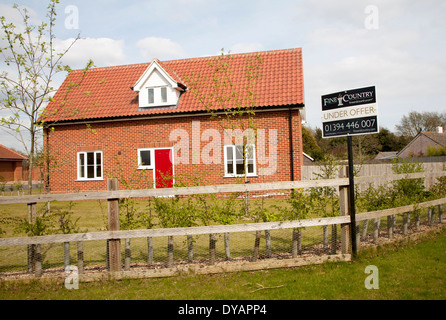 Fine and Country estate agent sign Under Offer outside modern house, Suffolk, England Stock Photo