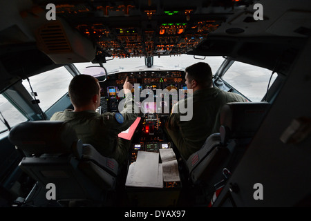 Nick Horton, left, and Lt. Clayton Hunt, naval aviators assigned to Patrol Squadron (VP) 16, perform preflight checks in the flight station of a P-8A Poseidon prior to a mission to assist in search and rescue operations for Malaysia Airlines flight MH370. VP-16 is deployed in the U.S. 7th Fleet area of responsibility supporting security and stability in the Indo-Asia-Pacific region. (U.S. Navy photo by Chief Mass Communication Specialist Keith DeVinney/Released) Stock Photo