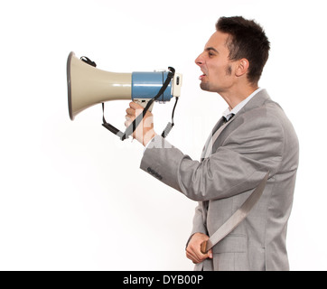 Handsome young caucasian businessman yelling on megaphone Stock Photo