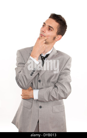 Handsome young caucasian businessman looking up and thinking Stock Photo