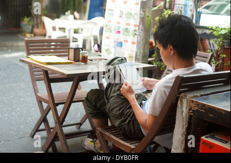 Bangkok Thailand young man with digital tablet Stock Photo