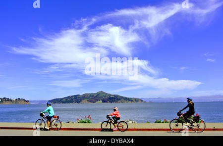 family of cyclists ride on Bridgeway in Sausalito California Stock Photo
