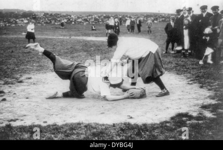 New York Female Giants - Miss Schnall sliding to first. Miss Morgan on bag. 1913 Stock Photo
