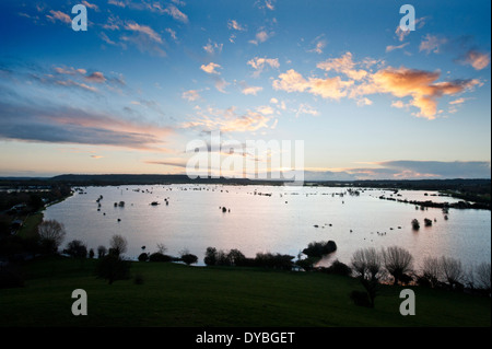Dawn breaks over the flooded fields of the Somerset Levels with water pouring from the River Parrett into Southlake Moor UK Stock Photo
