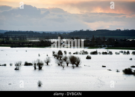 Dawn breaks over the flooded fields of the Somerset Levels with water pouring from the River Parrett into Southlake Moor UK Stock Photo