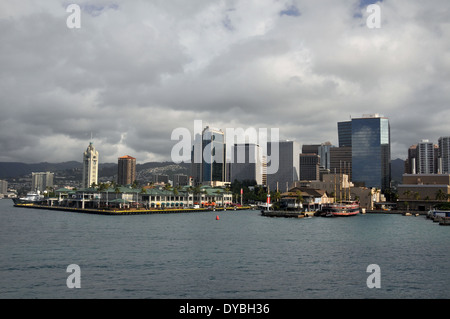 Aloha Tower and downtown Honolulu viewed from the ocean in a cloudy day, Oahu, Hawaii, USA Stock Photo