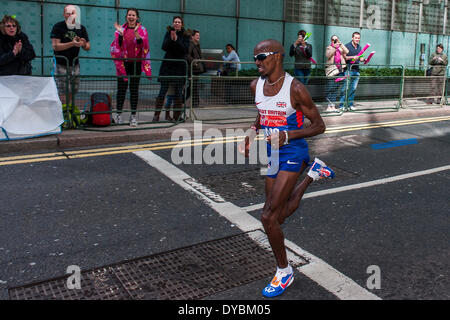London, UK. 13th Apr, 2014. Mo Farah passes through Canary Wharf about thirty seconds behind the leaders. The London Marathon starts in Greenwich on Blackheath passes through Canary Wharf and finishes in the Mall. London UK, 13 April 2014.  Guy Bell, 07771 786236 guy@gbphotos. Stock Photo