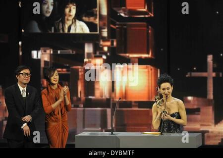 Hong Kong, Hong Kong Film Awards (HKFA) in south China's Hong Kong. 13th Apr, 2014. Kara Hui (R), the winner of the Best Supporting Actress award for her performance in the movie 'Rigor Mortis', shows the trophy during the presentation ceremony of the 33rd Hong Kong Film Awards (HKFA) in south China's Hong Kong, April 13, 2014. Credit:  He Jingjia/Xinhua/Alamy Live News Stock Photo