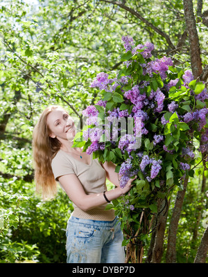 happy young woman in park with a big bouquet of a lilac Stock Photo