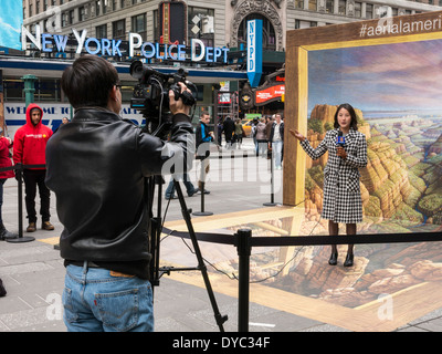 Japanese Female Video Reporter Being Filmed in front of Kurt Wenner's 3D Pavement  Drawing  of The Grand Canyon, NYC, USA Stock Photo
