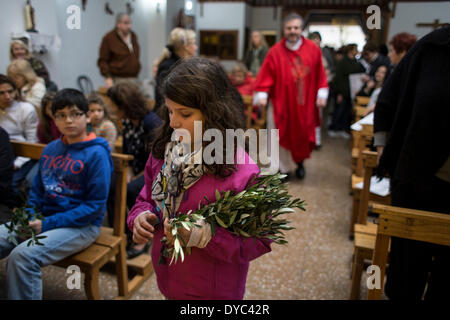 Buenos Aires, Argentina. 13th Apr, 2014. A girl attends a mass during Palm Sunday celebrations in Buenos Aires, capital of Argentina, on April 13, 2014. The Palm Sunday marks the beginning of Holy Week in the Roman Catholic calendar. Credit:  Martin Zabala/Xinhua/Alamy Live News Stock Photo