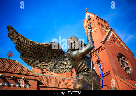 Statue of Archangel Michael thrusting spear into dragon before the Catholic Church of St. Simon and St. Helena in Minsk, Belarus Stock Photo