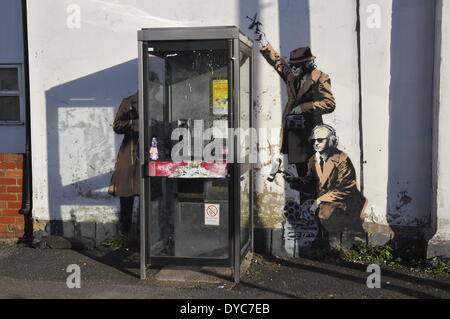 Cheltenham, UK . 14th Apr, 2014. Possible Banksy artwork outside a public telephone box satirising surveillance of citizens' conversations. Credit:  foto-call/Alamy Live News Stock Photo