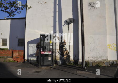 Cheltenham, UK . 14th Apr, 2014. Possible Banksy artwork outside a public telephone box satirising surveillance of citizens' conversations. Credit:  foto-call/Alamy Live News Stock Photo