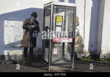 Cheltenham, UK . 14th Apr, 2014. Possible Banksy artwork outside a public telephone box satirising surveillance of citizens' conversations. Credit:  foto-call/Alamy Live News Stock Photo