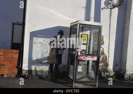 Cheltenham, UK . 14th Apr, 2014. Possible Banksy artwork outside a public telephone box satirising surveillance of citizens' conversations. Credit:  foto-call/Alamy Live News Stock Photo