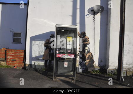 Cheltenham, UK . 14th Apr, 2014. Possible Banksy artwork outside a public telephone box satirising surveillance of citizens' conversations. Credit:  foto-call/Alamy Live News Stock Photo