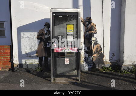 Cheltenham, UK . 14th Apr, 2014. Possible Banksy artwork outside a public telephone box satirising surveillance of citizens' conversations. Credit:  foto-call/Alamy Live News Stock Photo