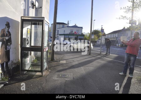 Cheltenham, UK . 14th Apr, 2014. Possible Banksy artwork outside a public telephone box satirising surveillance of citizens' conversations. Credit:  foto-call/Alamy Live News Stock Photo