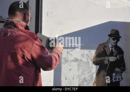 Cheltenham, UK . 14th Apr, 2014. Possible Banksy artwork outside a public telephone box satirising surveillance of citizens' conversations. Credit:  foto-call/Alamy Live News Stock Photo