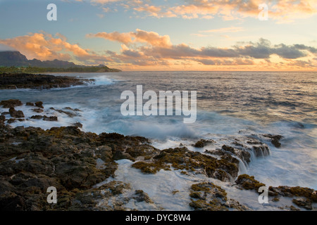 The sea cliffs and surf at sunrise near Shipwreck Beach in Poipu, Kauai, Hawaii. Winter Stock Photo