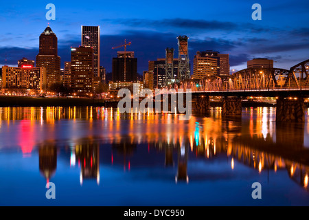 Downtown Portland, Oregon reflects off the Willamette River early in the evening. Portland, Oregon, USA Stock Photo