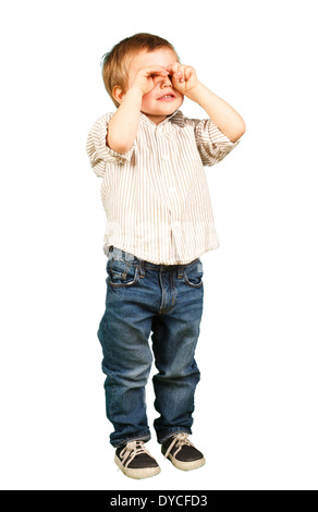 little boy puts his hand over his eyes Stock Photo