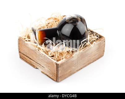 Bottles of wine or herbal syrup, in wooden box, over white background